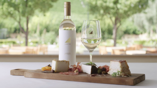 JUSTIN Wine – Lesson 5 – Crush It with JUSTIN – Pairing Wine and Food; Cheese and charcuterie board with a bottle of JUSTIN’s Sauvignon Blanc and a glass of white wine